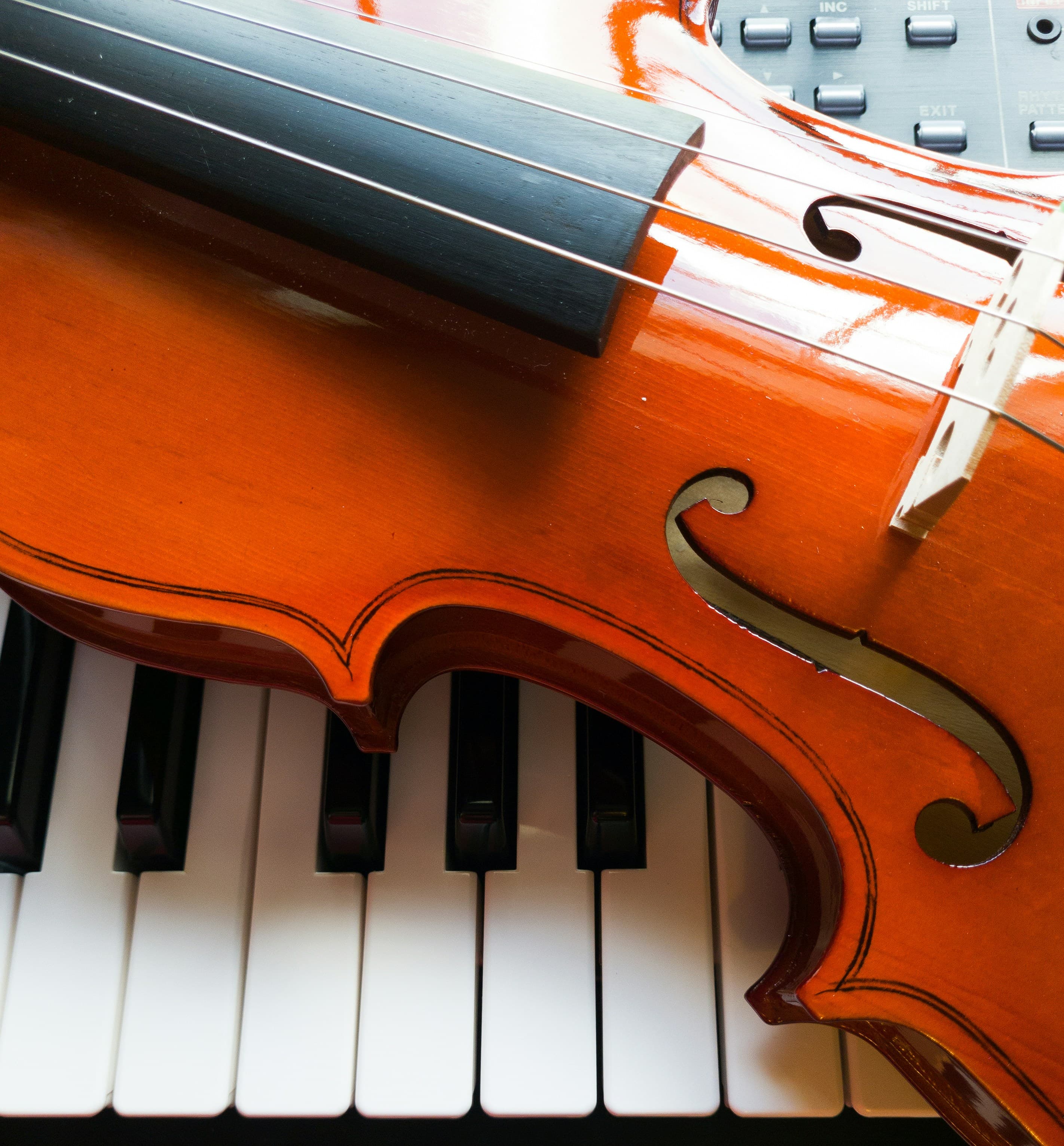 Violin resting over piano keys